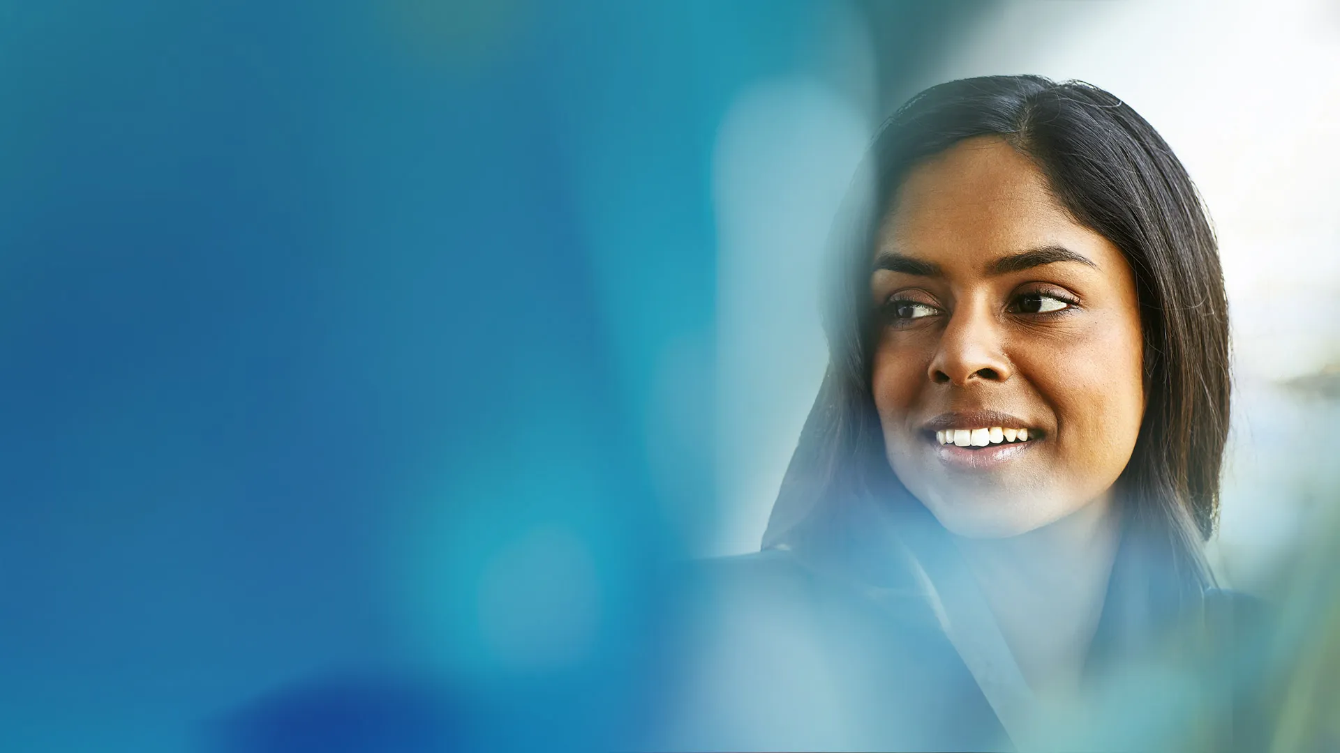 Close-up portrait of a female Asian professional, smiling at work